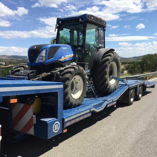 camión transportando tractor